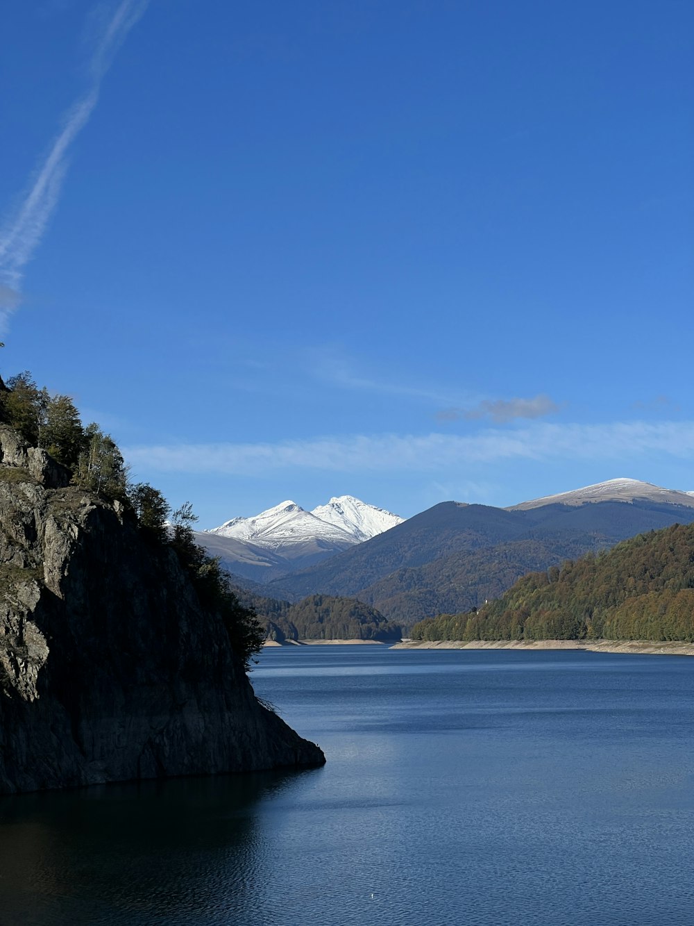 a body of water with a mountain in the background