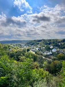 A peaceful Nigerian landscape showing open land and houses with green hues reflecting growth and opportunity.