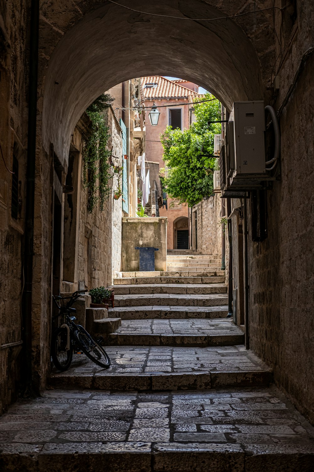 a bicycle is parked in a narrow alleyway