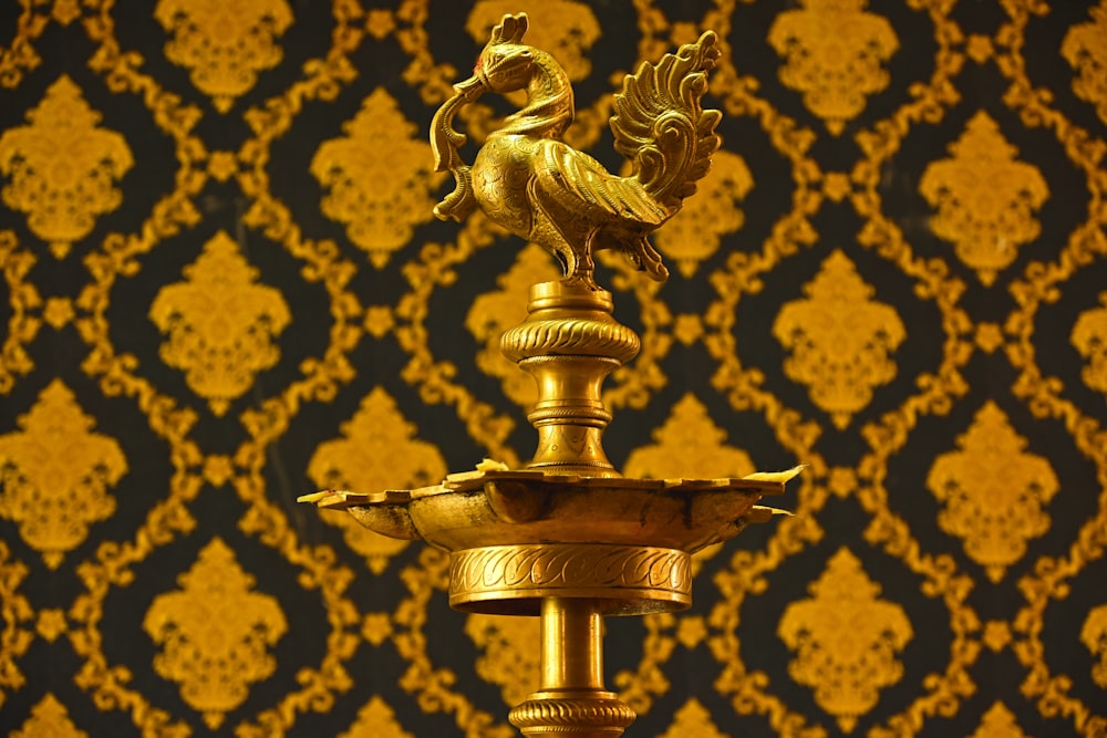a gold trophy with a golden eagle on top