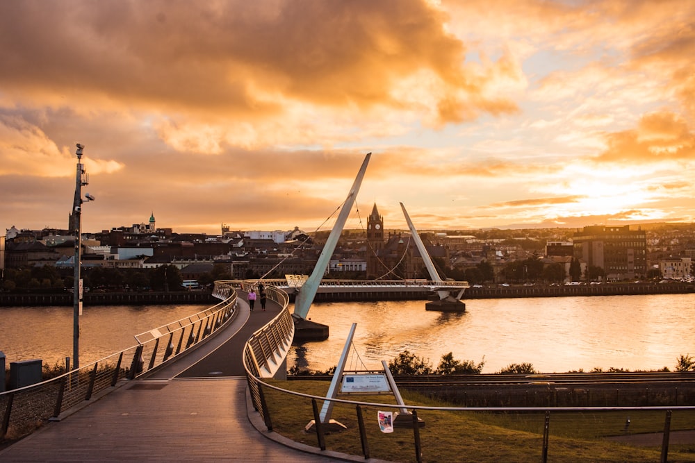 a bridge over water with a city in the background