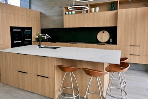 a kitchen with stools and a counter