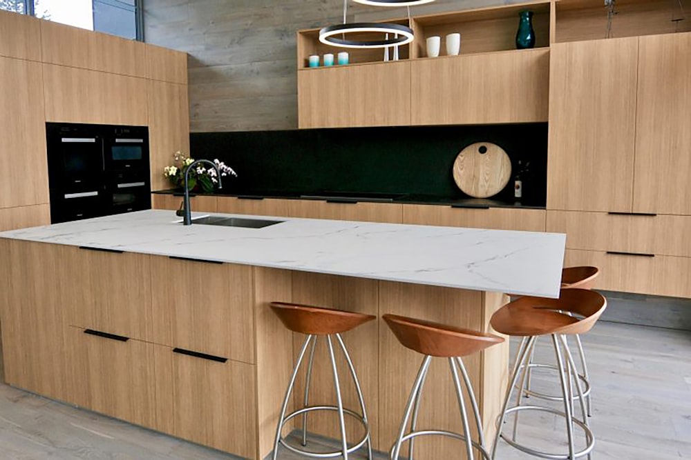 a kitchen with stools and a counter