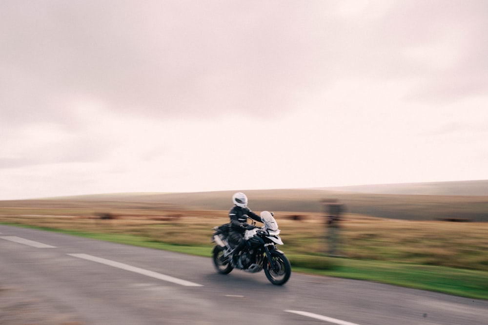 a man riding a motorcycle on a road