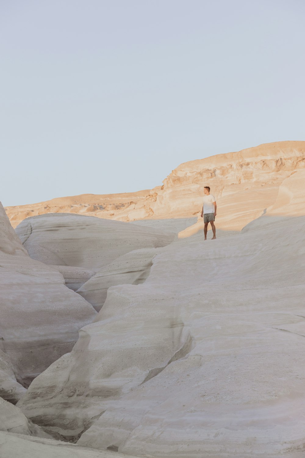 a person standing on a rocky hill