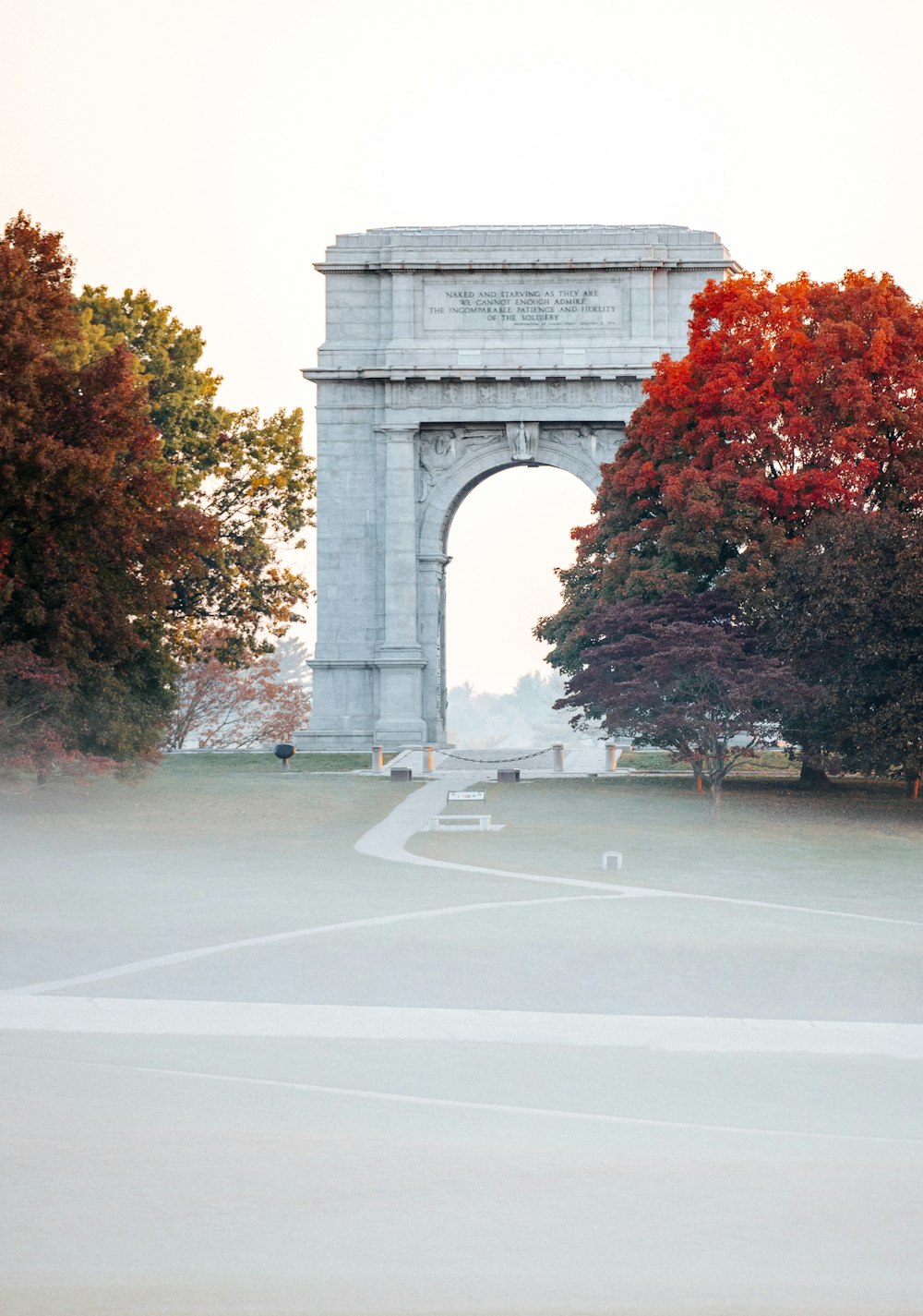 a large stone arch with trees around it