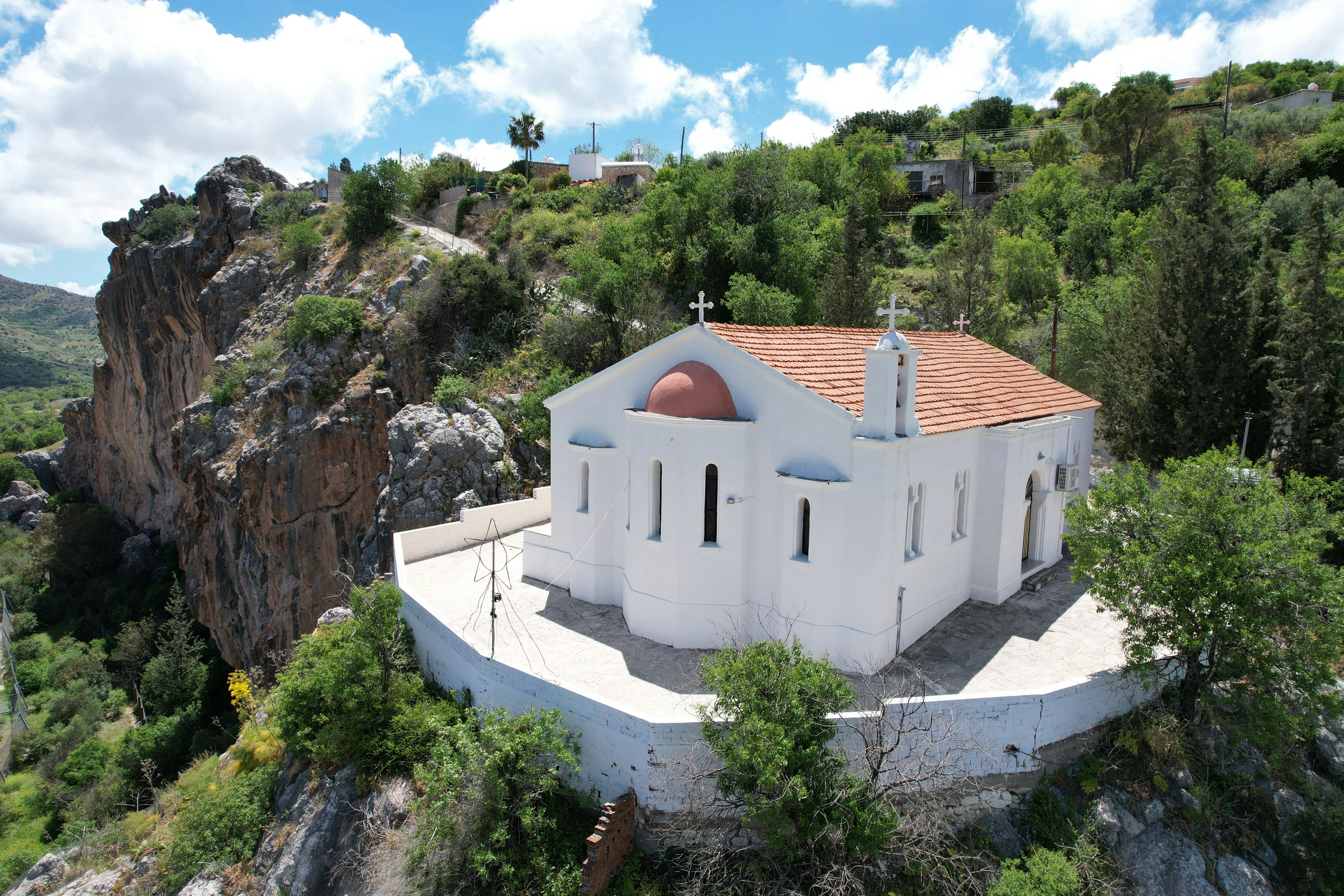 a white building on a rocky hill
