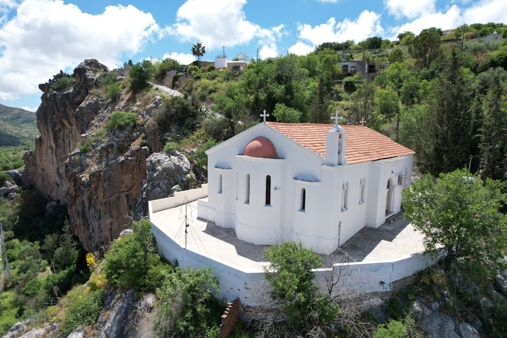 a white building on a rocky hill