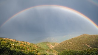 a rainbow over a mountain