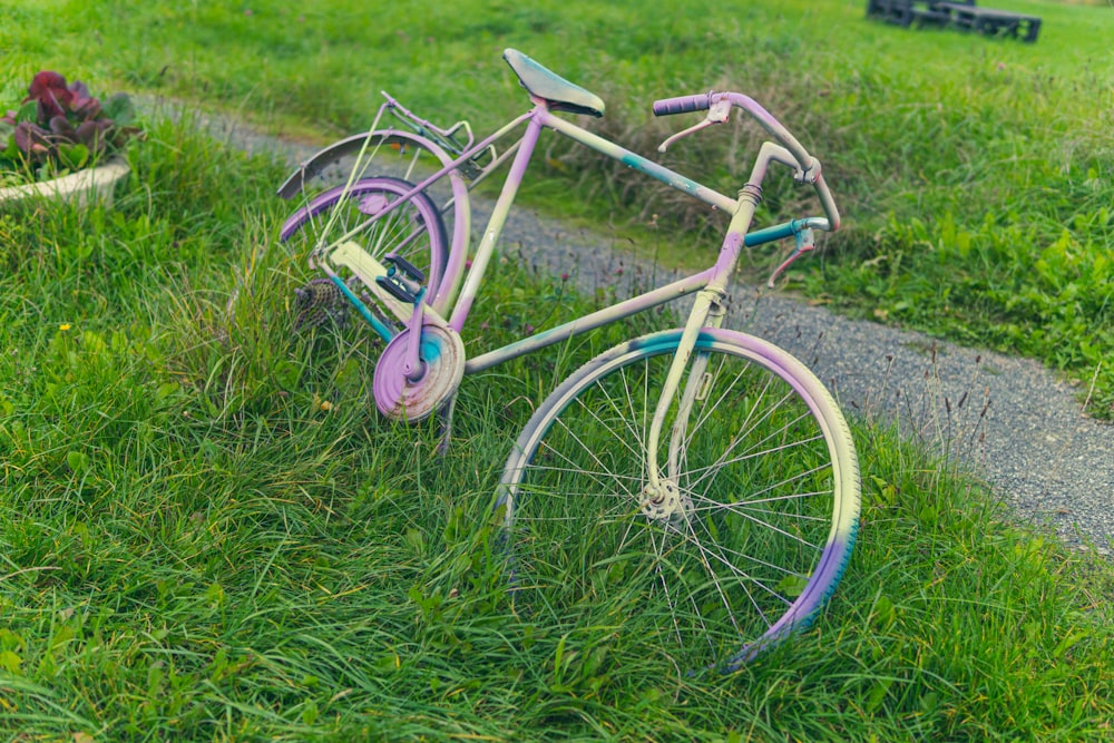 a purple bicycle in the grass