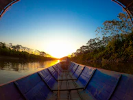 A serene view of the Amazon River near Iquitos at sunset.