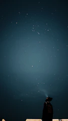 A thoughtful person gazing at a constellation map, reflecting deep human insight.