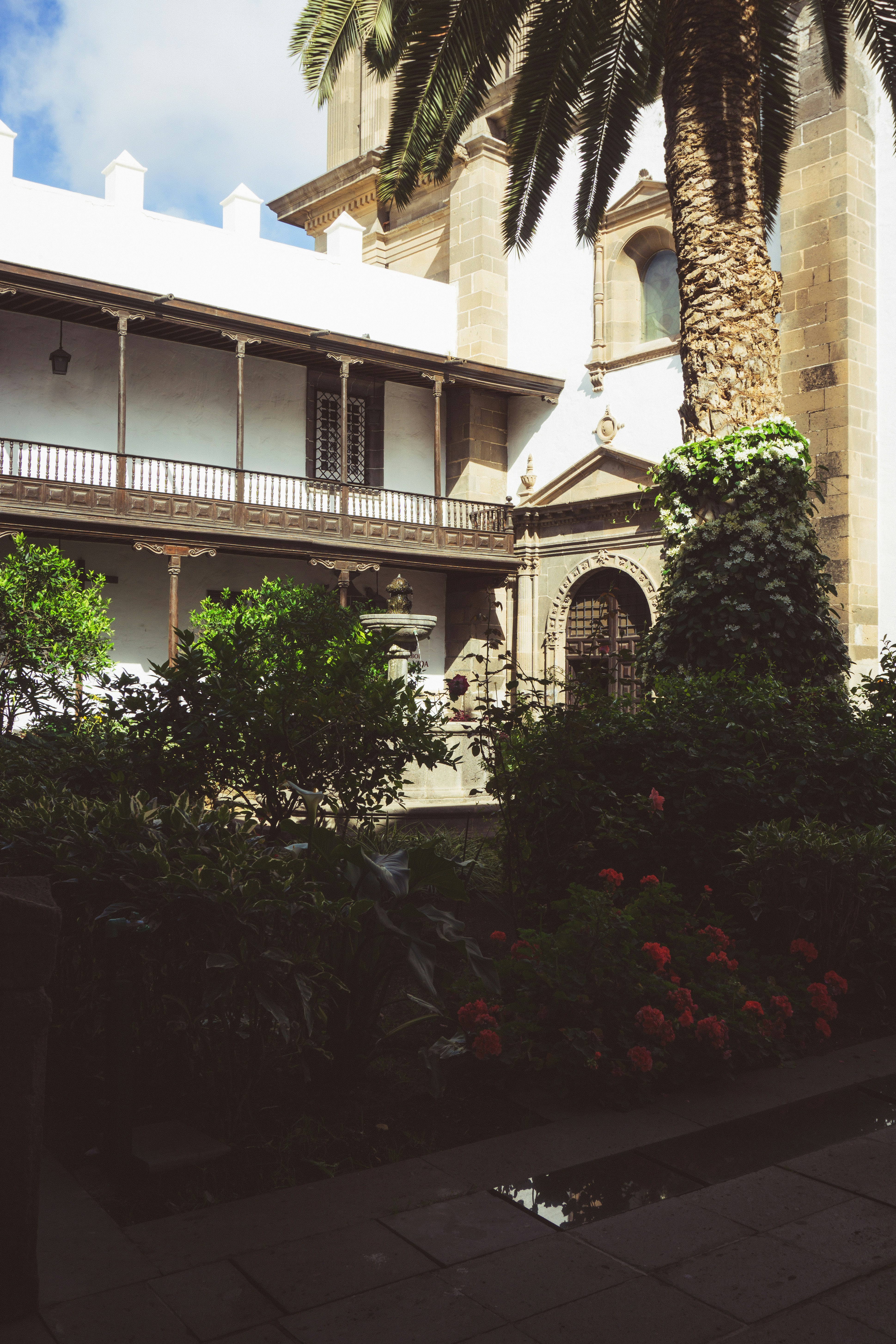 Luxury heritage hotel courtyard with marble fountain and tropical garden
