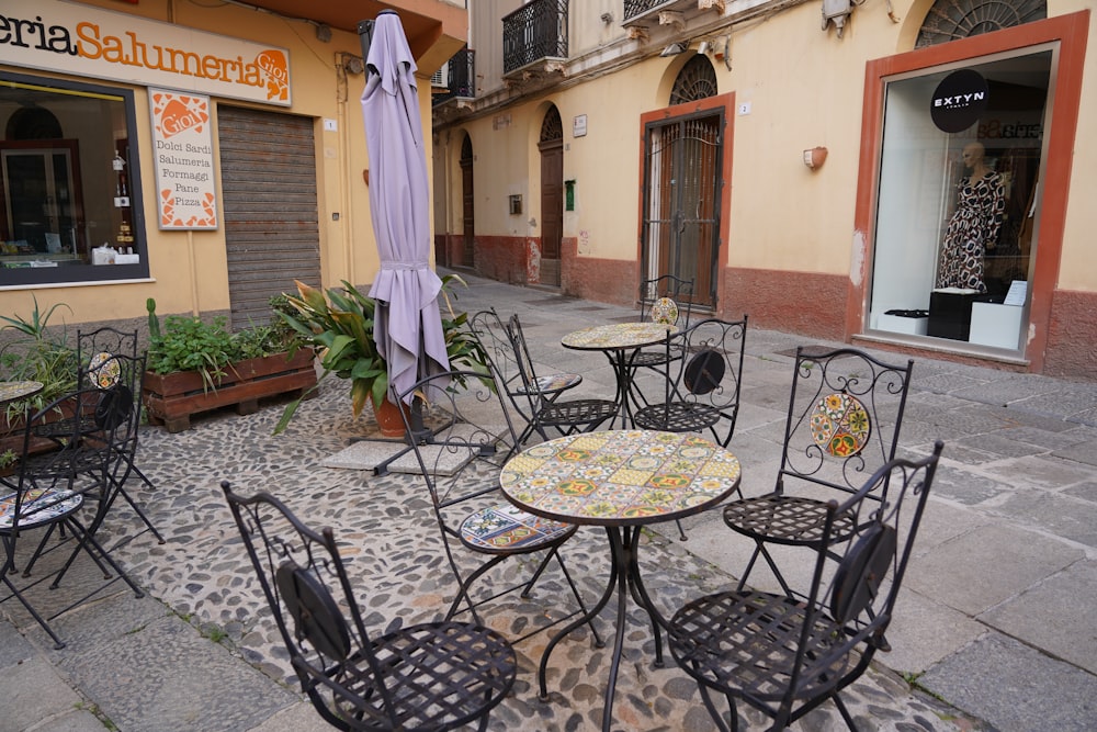 a group of tables and chairs outside a building