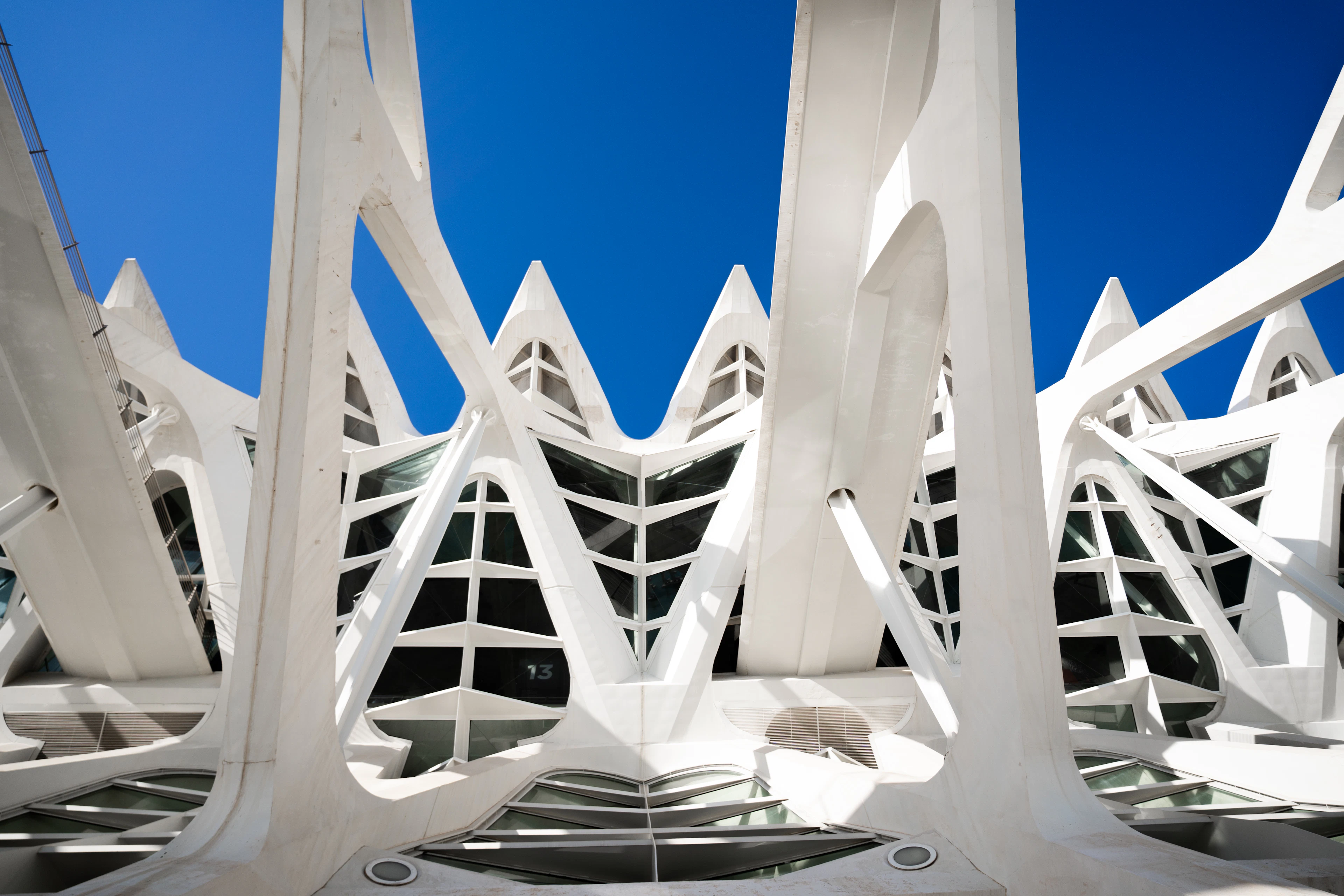 The ribbed white shell of Valencia's City of Arts and Sciences rises against a deep blue sky.