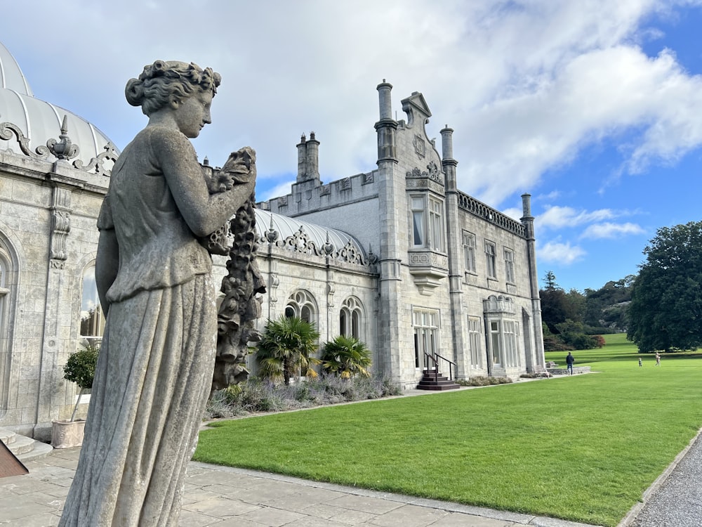 a stone statue in front of Bodelwyddan Castle