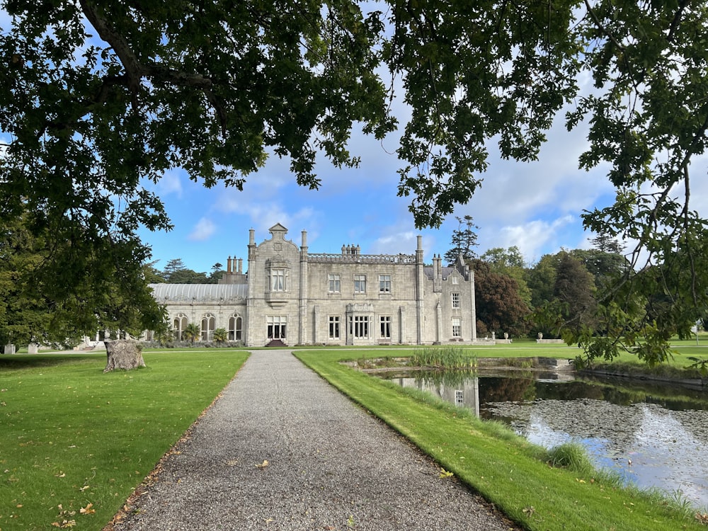 a large building with a pond in front of it