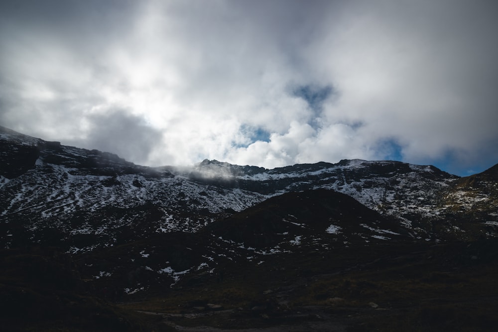 a mountain range with clouds