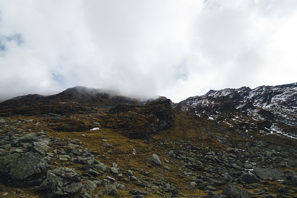 a rocky mountain with clouds