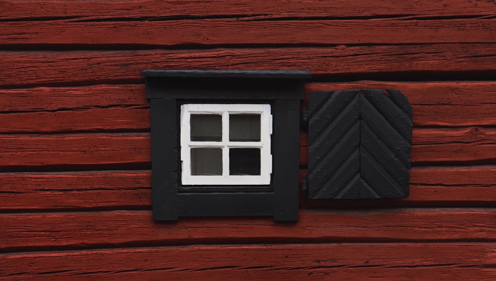 a couple of windows on a wood wall