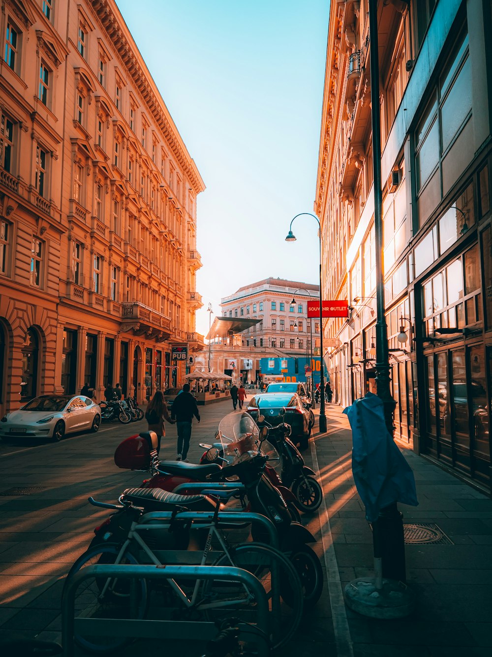 a city street with cars and people