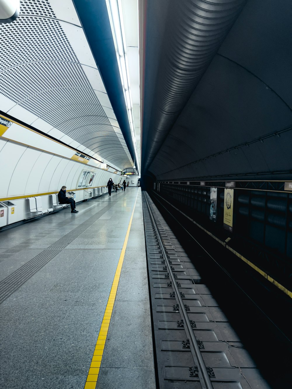 a train station with people walking