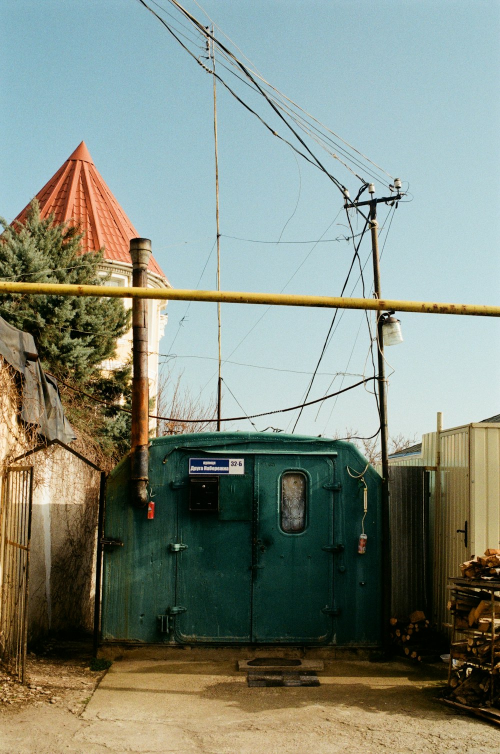 a green shed with wires