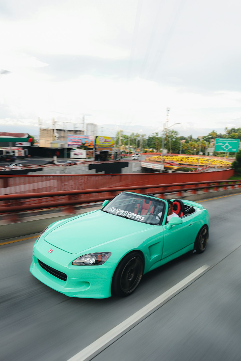 a green car on a road