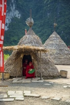 a group of people outside of a hut