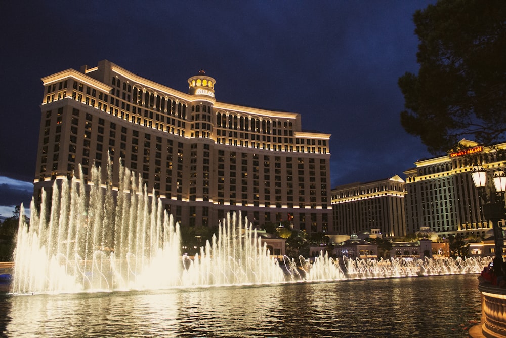 a large building with a fountain in front of it with Bellagio in the background