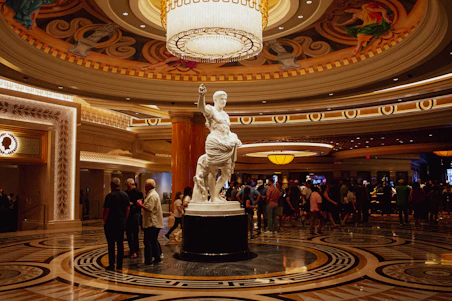 a large statue in a large room with people standing around
