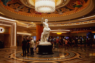 a large statue in a large room with people standing around