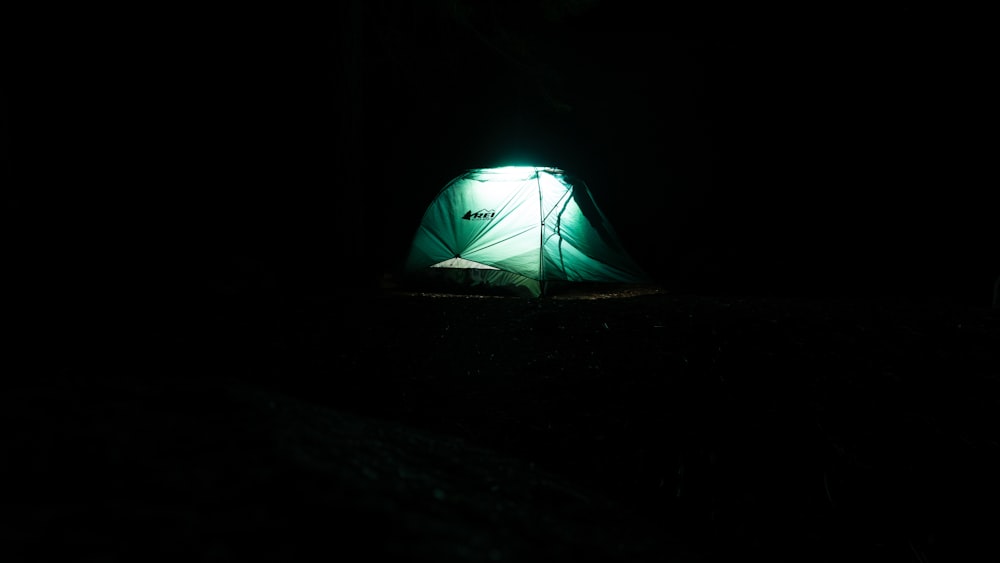 a green tent in the dark