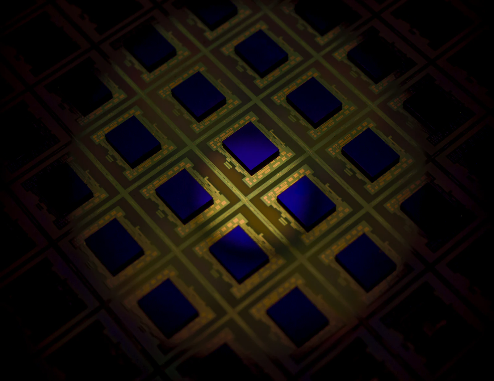 Macro view of a silicon wafer with a grid of chip dies