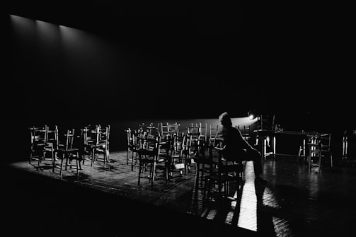 a person sitting on a chair in front of a row of chairs