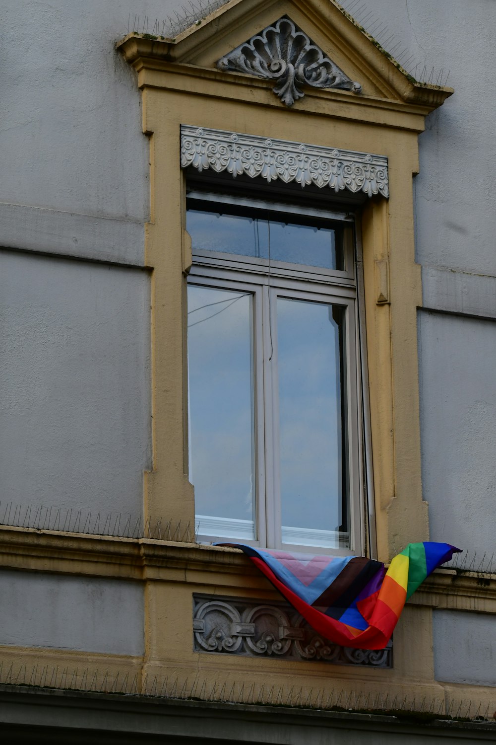 a kite is flying in front of a window