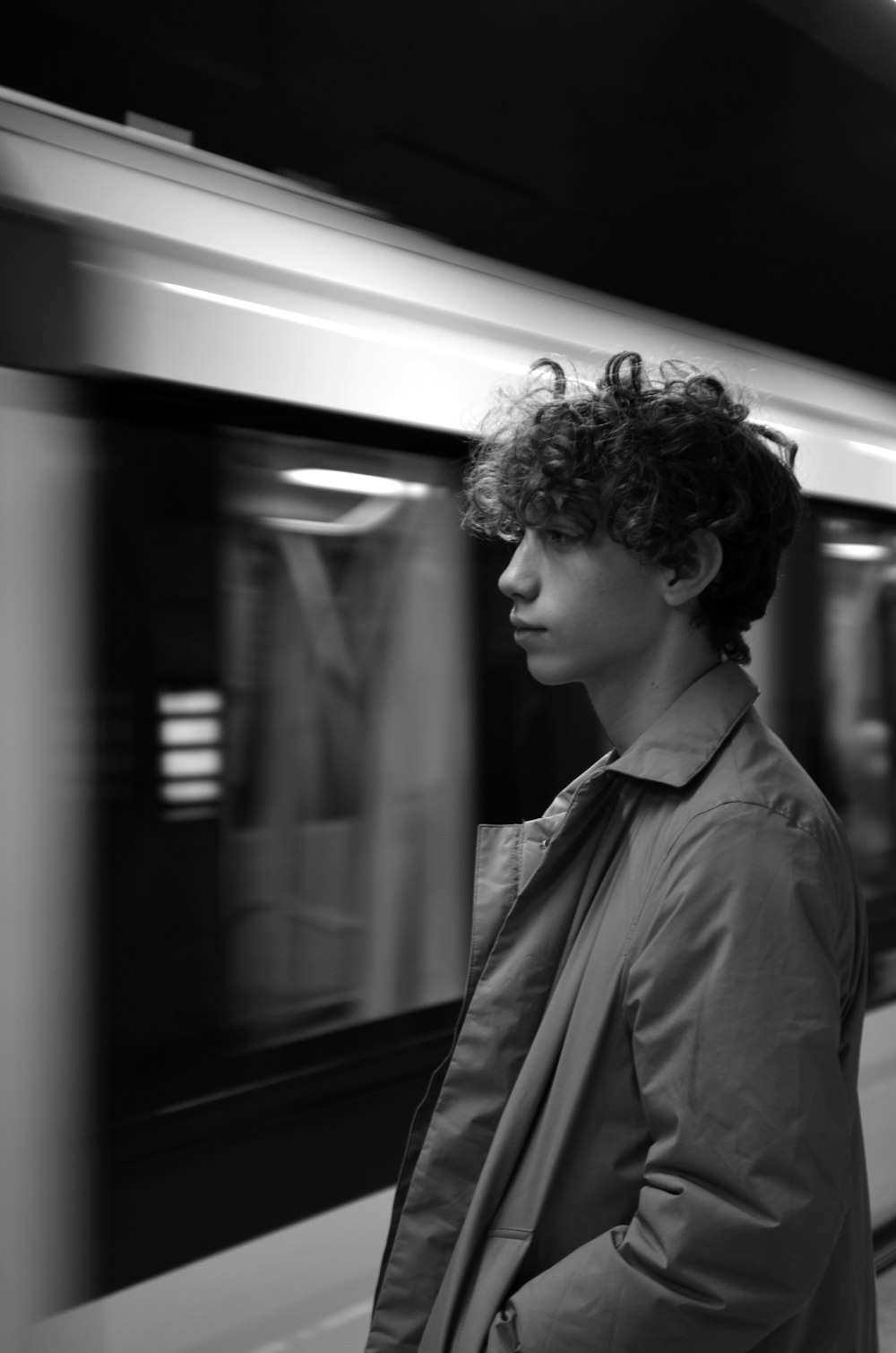 a person in a jacket looking out a window