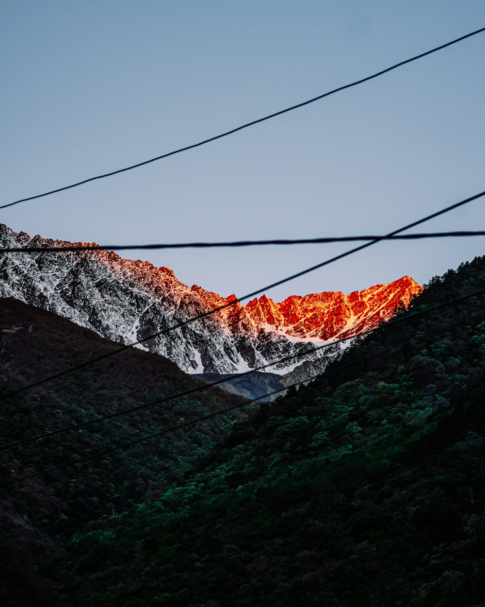 a snowy mountain with a cable car