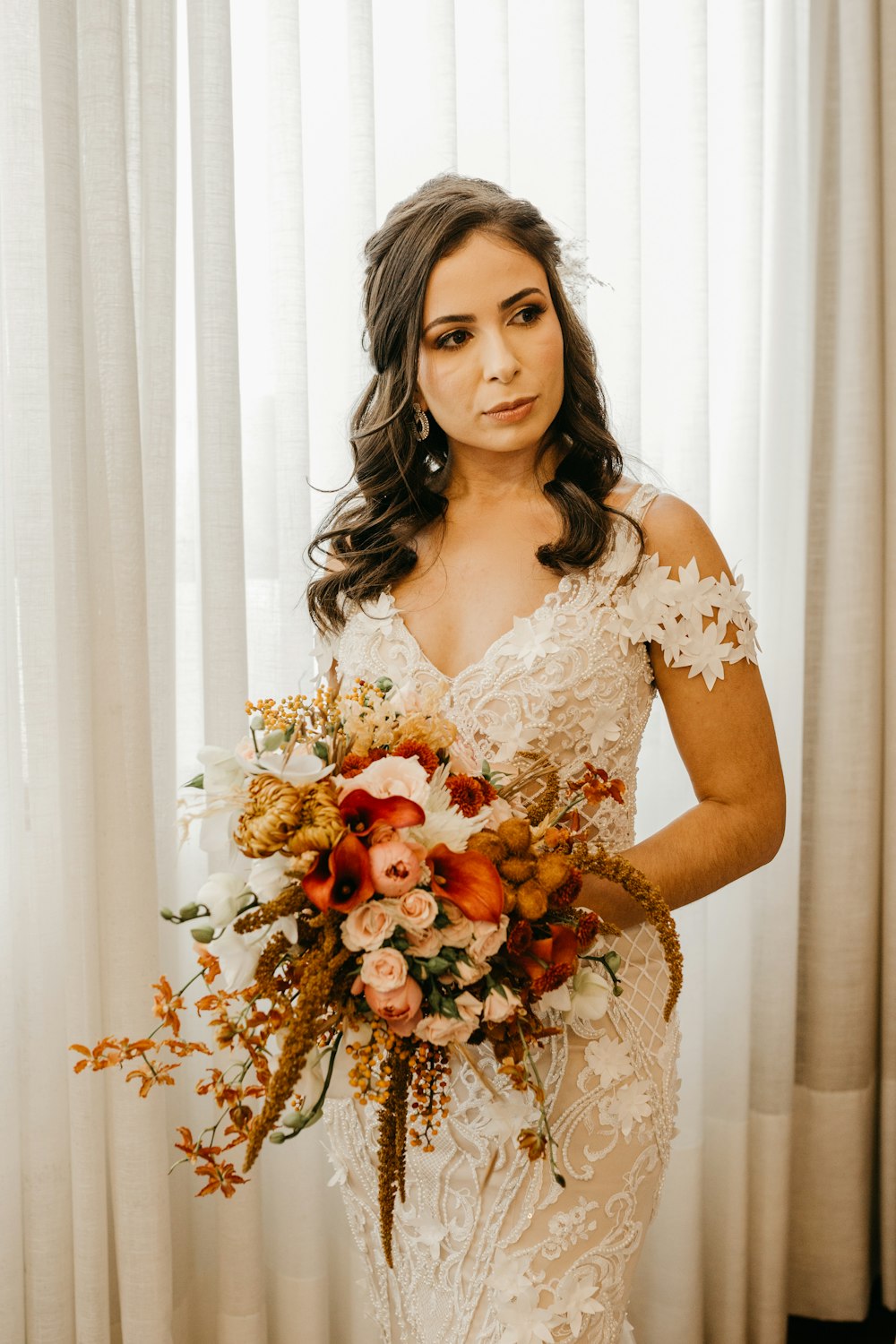 a woman in a white dress holding a bouquet of flowers