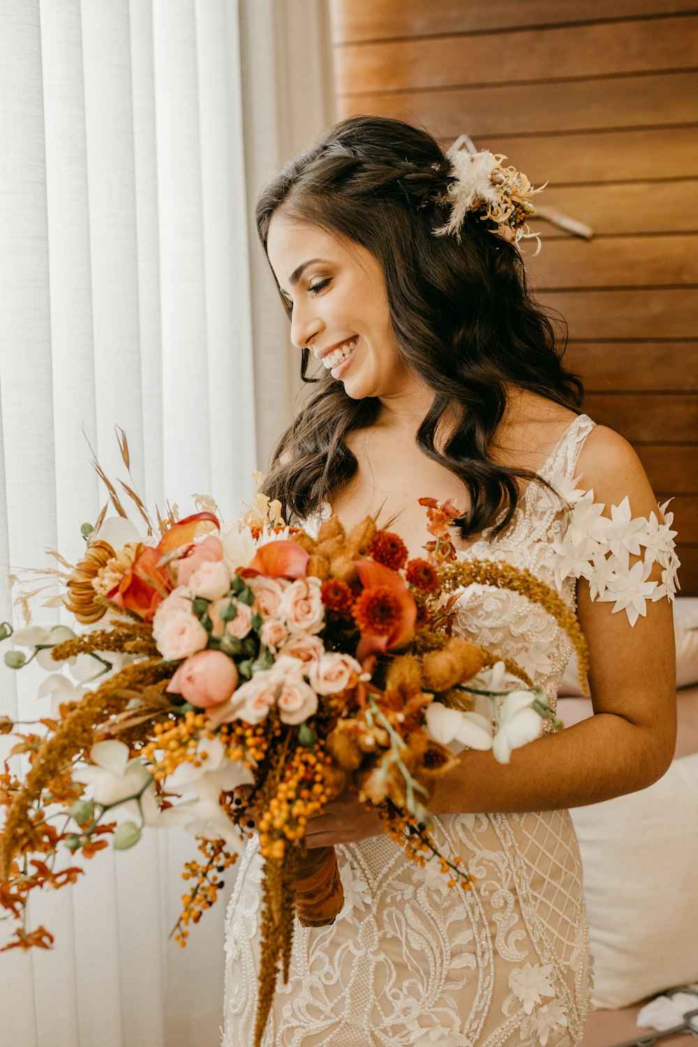 a woman in a white dress holding a bouquet of flowers