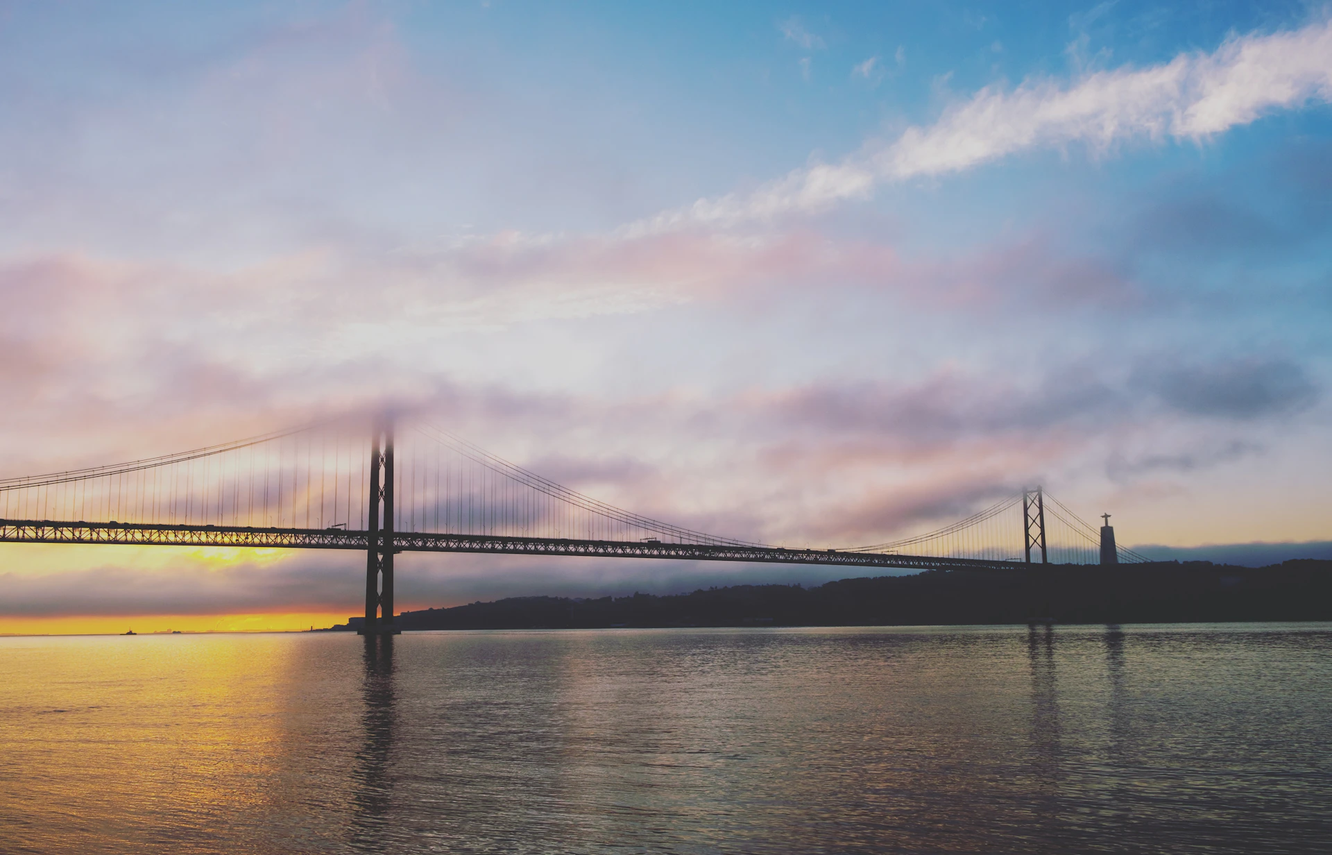 Colorful and detailed image of the Bridge of the Americas at sunset, highlighting its impressive structure over the water.