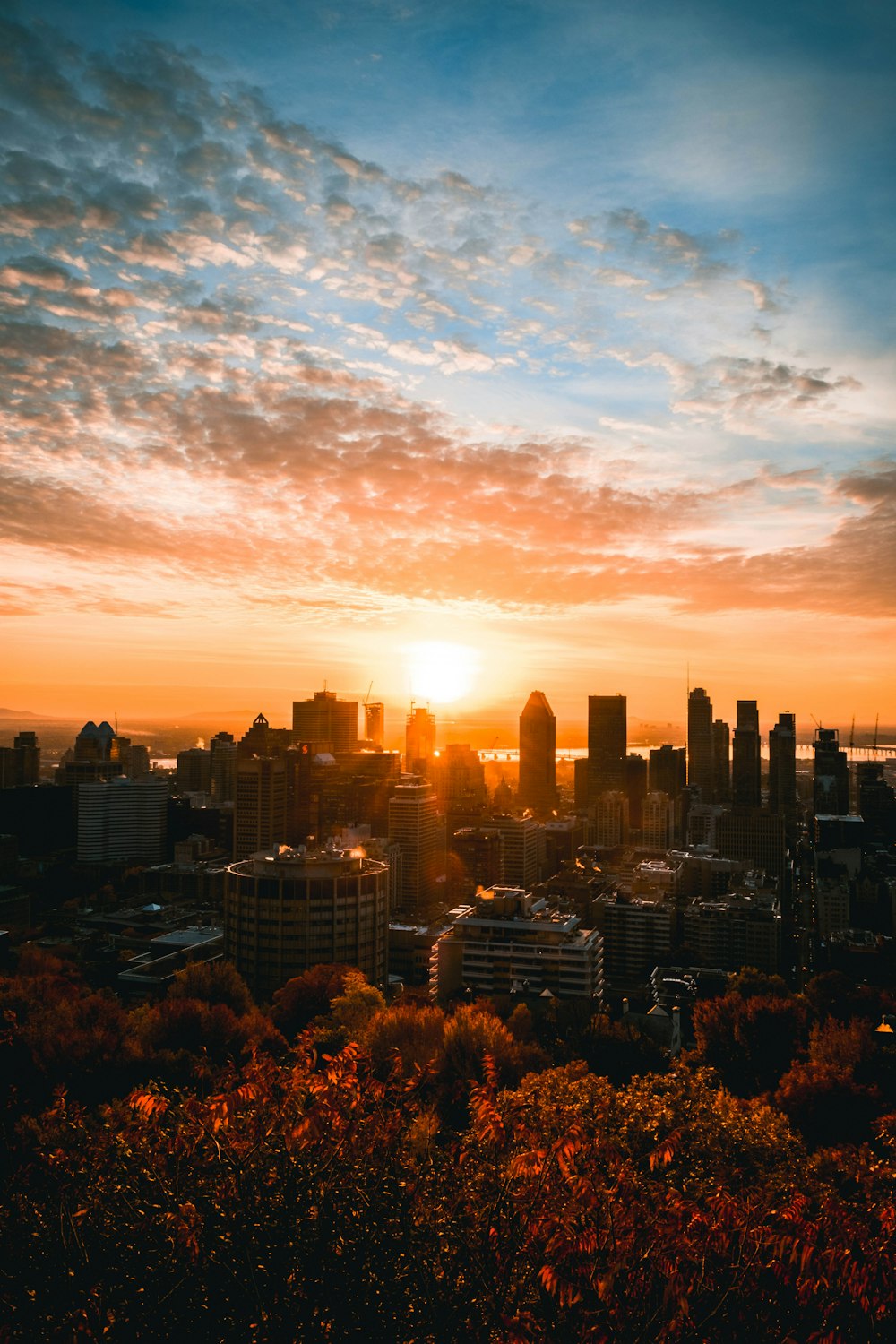 a city skyline with the sun setting