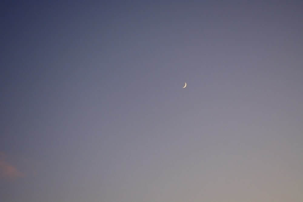a crescent moon in a blue sky