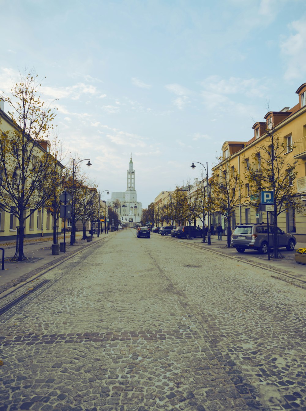 a street with cars and buildings on either side of it