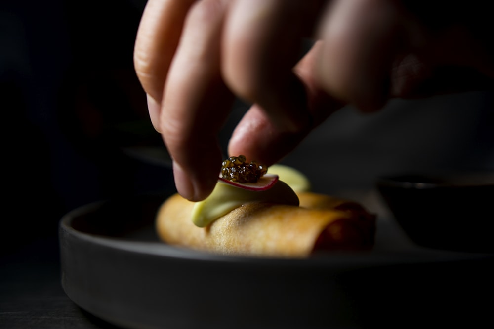 a person putting a ring on a fruit