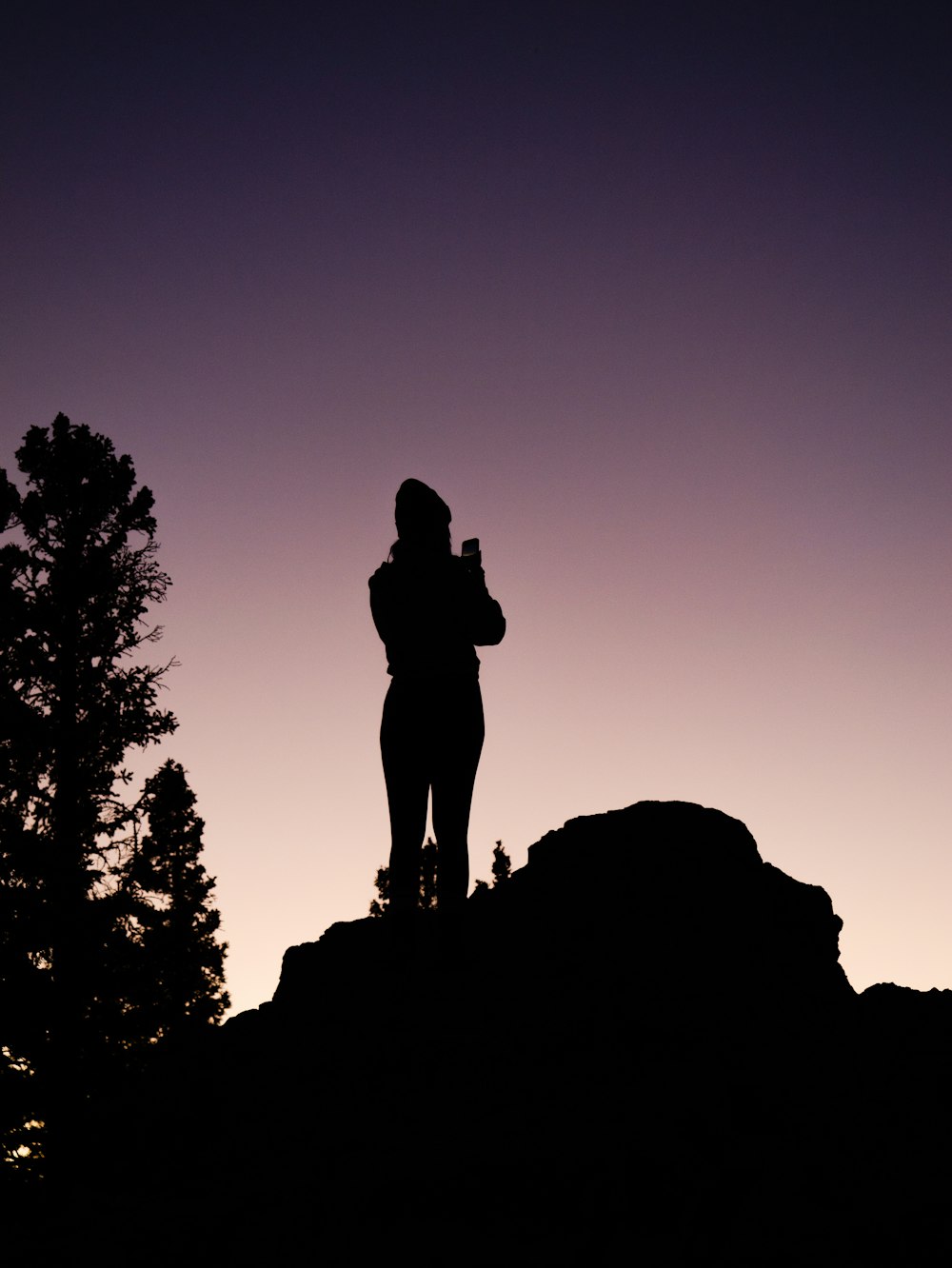 a statue of a person on a rock