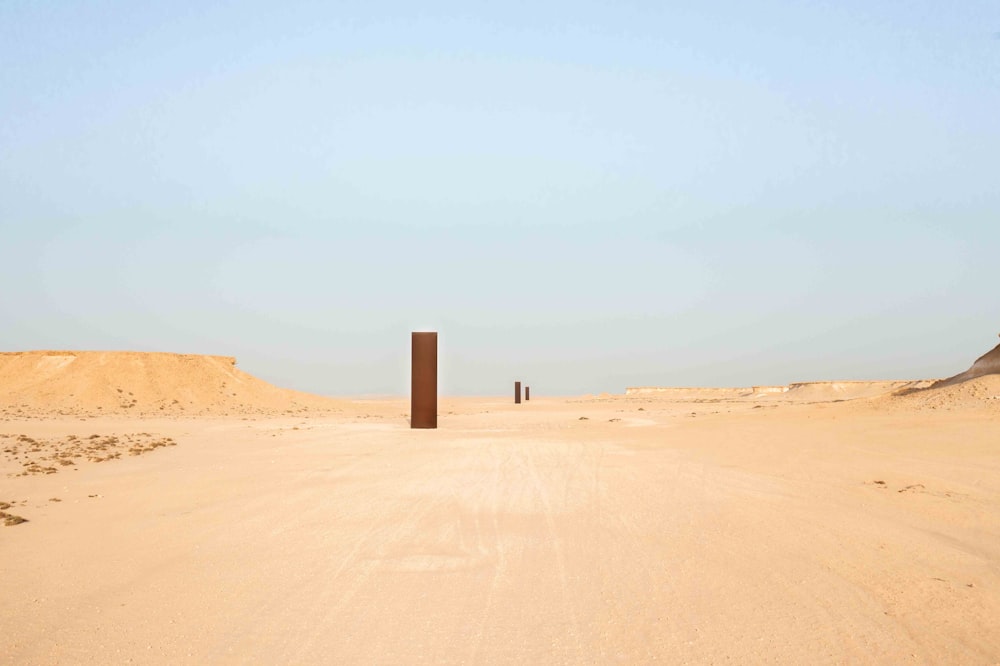 a sandy desert with a tall tower