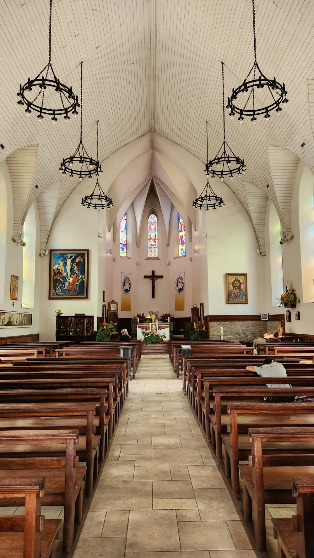 a large church with a large group of pews and stained glass windows