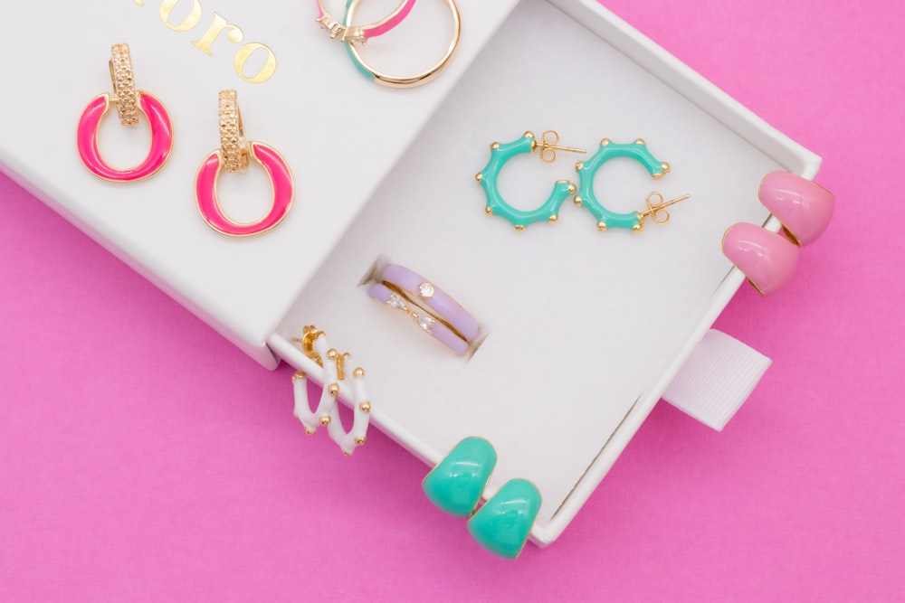 a pink table with a few earrings