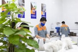 Technicians performing sampling in a manufacturing facility.